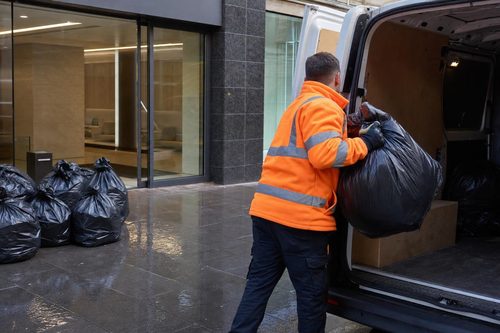 Sealed confidential waste sacks being loaded from a London office
