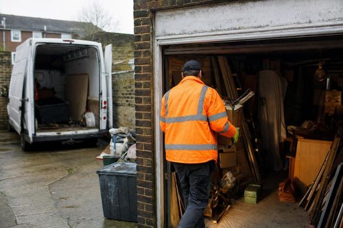 A cluttered London garage being cleared into a van